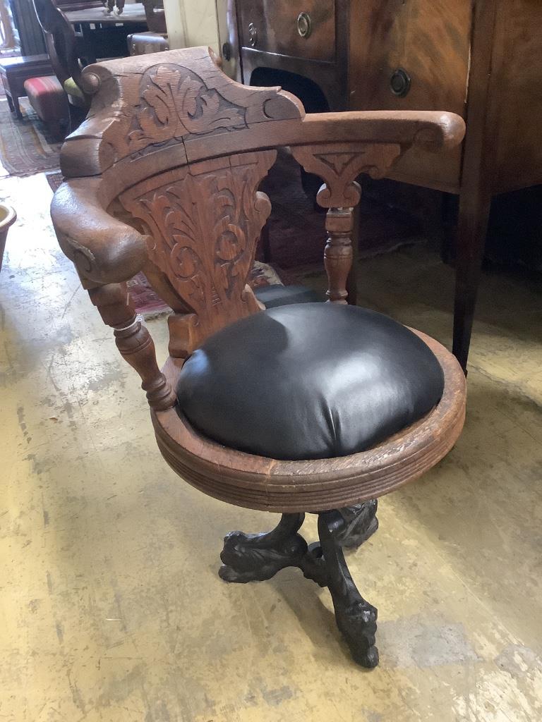 A continental carved oak and cast iron music chair